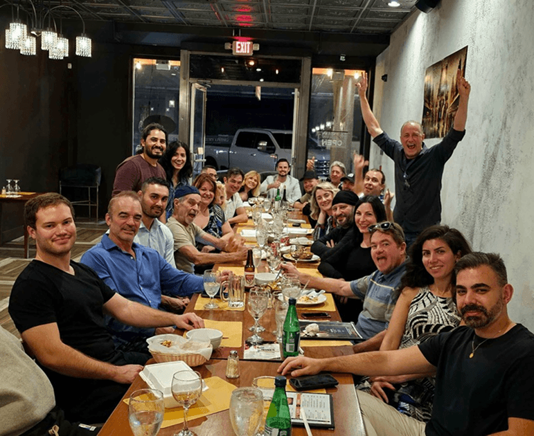 Happy returning restaurant customers being welcomed back by staff